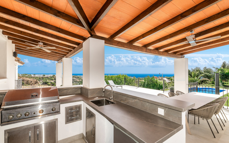 outdoor kitchen and bbq looking on to the swimming pool