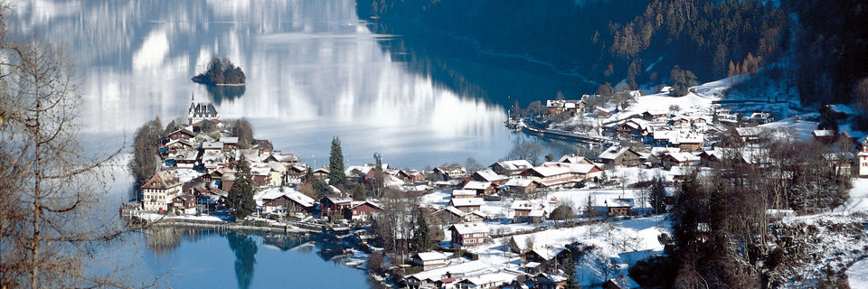 iseltwald village covered in snow on lake brienz