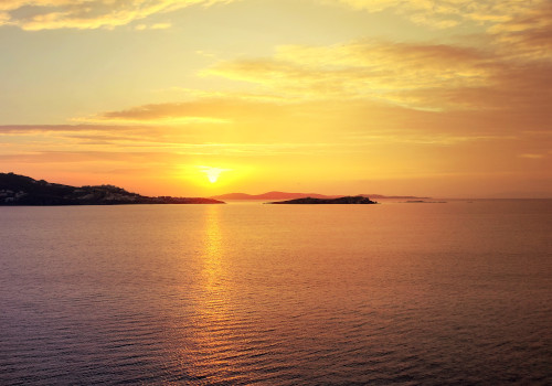 sunset over agios lazoros beach mykonos