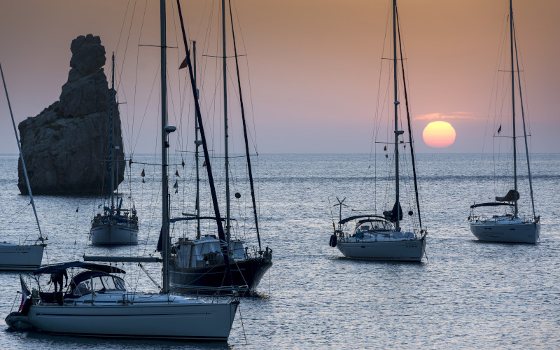 cala vadella sailing boats at sunset