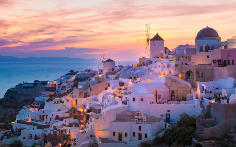 villas looking on to mykonos town at sunset