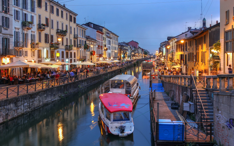 boats in the milan canal alongside the restaurants